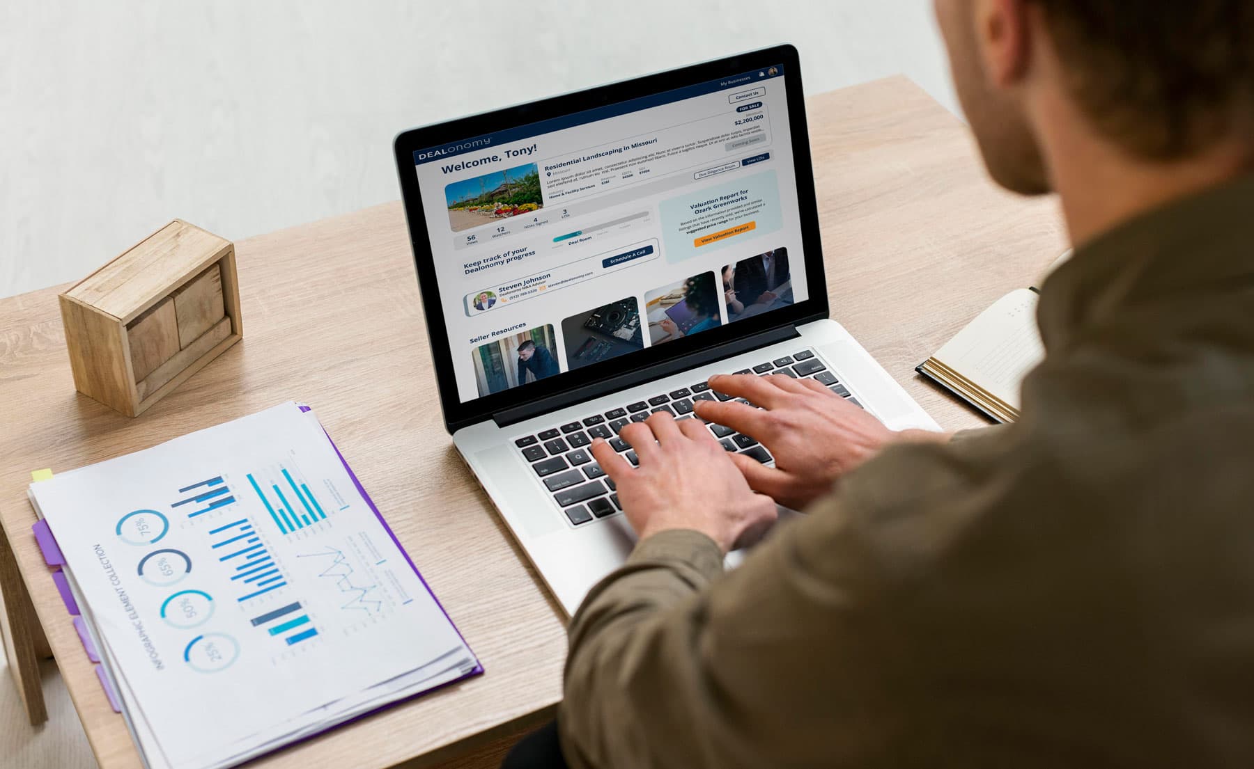 Person working on laptop reviewing business valuation